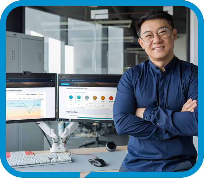 Person standing in front of their computer desk with the Amazing Workplace Platform open on their screen.