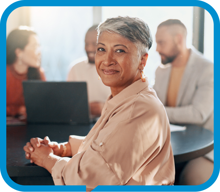 Person smiling while attending a workplace meeting